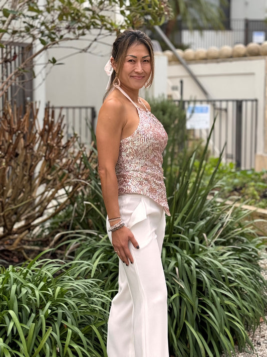 Chrystal Sloane Couture New Season Peach & Bronze Sequined Stretch Drawstring Halter Top with cream wide leg pant.